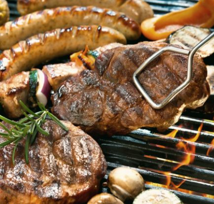 Meat, sausages and vegetables on the barbecue grill