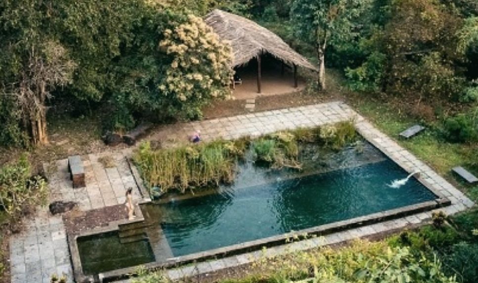 The natural swimming pool at Dudhsagar Plantation farm stay in South Goa, seen from above